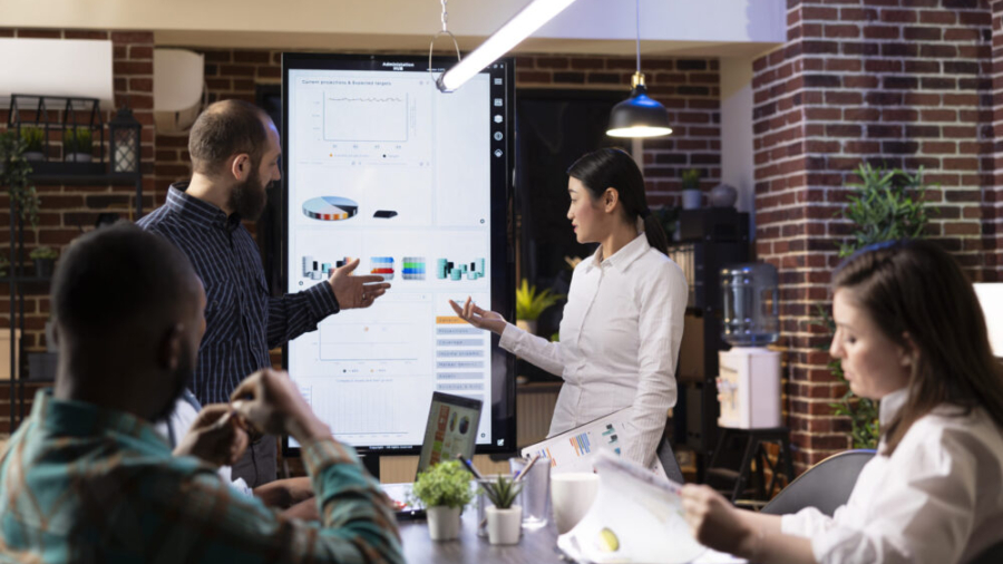 team reviewing marketing strategies on digital screen
